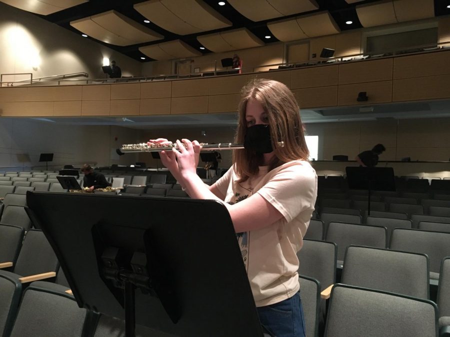 Freshman Rowan Lefferts plays the flute with COVID protocols. 